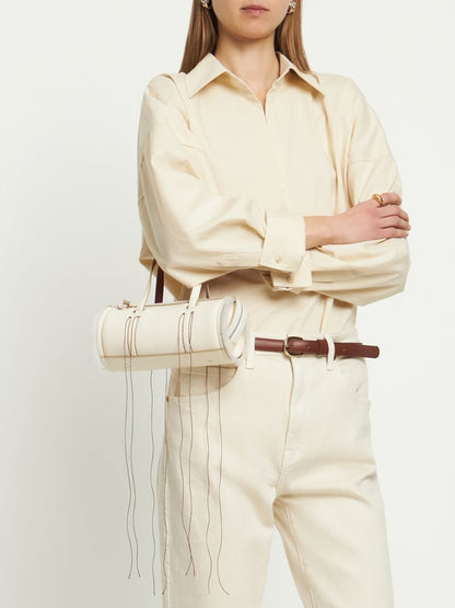 Cream Leather Cylinder Handbag With Decorative Fringe Stitching