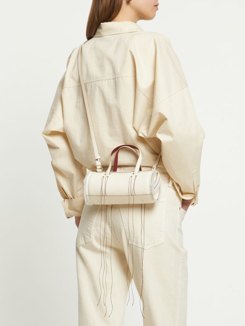 Cream Leather Cylinder Handbag With Decorative Fringe Stitching