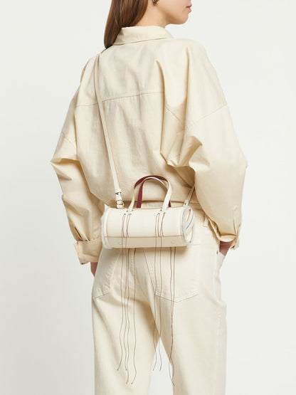 Cream Leather Cylinder Handbag With Decorative Fringe Stitching